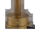 Close-up of ribbed metal base with circular on/off switch and subtle horizontal grooves