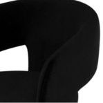 Close-up of chair’s curved armrest and upholstery texture with subtle seam detail