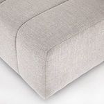 Close-up of outer armrest with prominent channel stitching and tightly woven upholstery fabric