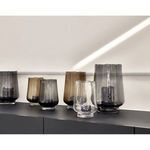 Elyza vases in multiple sizes and smoky colors displayed on black surface with candleholders inside
