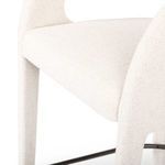 Side close-up of seat cushion and front leg detailing with visible black metal footrest below.