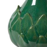 Close-up on glossy green lotus petal details and natural texture variation on ceramic lamp base
