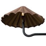 Underside of scalloped shade showing antiqued brass interior and lit bulb inside