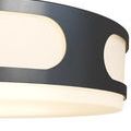 Close-up of side view showing smooth black powder-coated metal frame surrounding illuminated milky white glass