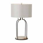 Joan Table Lamp shown lit from front, highlighting its white linen drum shade