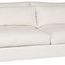 Three-quarter view highlighting left arm and deep seating of white upholstered sofa