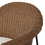 Detailed texture view of woven brown material on armrest and upper chair back