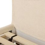 Close detail of side rolled footboard edge with cream fabric and smooth curved form