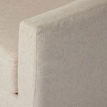 Close-up of oatmeal fabric upholstery showing subtle texture and stitch detail on armrest
