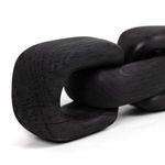 Close-up detail of black wood link showing smooth edges and grain patterns