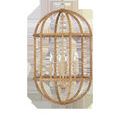 Oval-shaped chandelier with a natural rattan reed frame and four candle-style lights inside