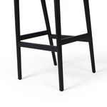Angled side view highlighting curved backrest and seat leather