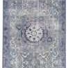 Top-down view displaying full vintage medallion pattern and cool-toned color variation of rug.