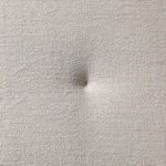 Zoomed fabric cushion detail showing tufted beige upholstery with textured weave