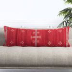 Pillow displayed on sofa angled slightly to show depth and full embroidered front pattern