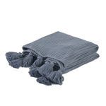 Kerith throw blanket folded at an angle showing tassels and side knit texture
