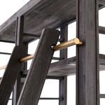 Close-up of brass-finished iron bar holding decorative pine ladder against dark anthracite pine frame