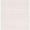 Handwoven outdoor rug with diamond trellis pattern in tan and cream, subtle distressed neutral hues