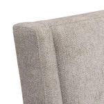 Close-up of upholstery corner seam and wood grain detail on Linea side chair leg