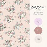 Wallpaper sample with brand logo and three circular paint swatches labeled Lilac Tree, Lady Moon, and Cotton Canvas