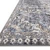Close-up angled view showing rug’s detailed patterned edge and low pile texture