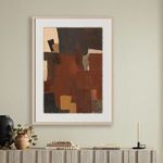 Abstract painting on beige wall with black candlestick and pottery decor on mantel