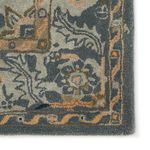 Detailed close-up of corner with dense pile featuring floral and geometric motifs