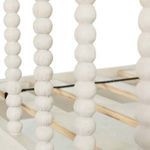 Close-up of spindle detailing on Jennifer Twin Bed’s headboard with textured antique white paint