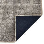 Corner flipped back showing dark backing fabric and edge stitching in natural thread