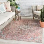 Indoor living room with rug between wicker sofas and metallic side table, showing scale and blending vintage style
