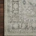 Close-up of the rug corner on dark wood floor showing detailed pattern and soft pile
