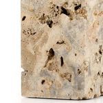 Close-up of side edge highlighting rough texture with multiple natural holes and pits