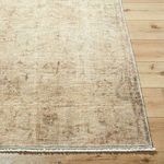 Close-up of rug corner showing detailed distressed pattern and textured machine-woven edges on wooden floor