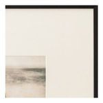 Detail close-up of textured cream matte board and seascape print corner within black frame