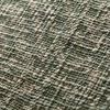 Close-up view showing woven texture and detailed block print of green and beige cotton fabric