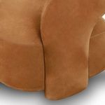 Close-up highlighting curve of thick armrest with detailed leather grain and seams