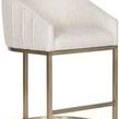 Side angle showing slanted barrel seat and matte brass metal base with footrest bar