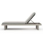 Side profile of chaise with backrest partially reclined, showing sleek frame and support bar
