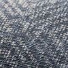 Close-up of textured blue and cream woven fabric showing detailed geometric pattern on the pillow
