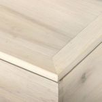 Close-up of trunk lid corner with mitered edge showing wood grain and smooth finish