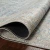 Curled corner close-up reveals dense weave and texture of the rug’s surface