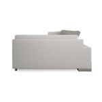 Opposite side profile view showing metal base on one end and pile of cushions on seating