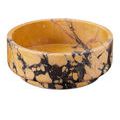 Slightly elevated view of the bowl emphasizing the rounded rim and marbled stone texture