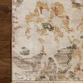 Top corner detail of rug laid on wooden floor emphasizing floral pattern and binding