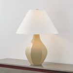 Lamp turned on, showing warm light glowing through white linen shade