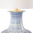Close-up of the lamp's blue and white textured ceramic neck with gold accent beneath white shade