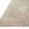 Slightly tilted angled view showing woven border and surface texture on natural colored power-loomed rug