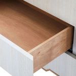 Open drawer showing smooth natural wood interior contrasting the textured silken grasscloth exterior