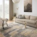 Soho Grey / Gold Rug styled in a bright living room with beige sofa and accent chair