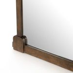 Close-up of bottom corner highlighting smooth rounded wood block and frame joinery